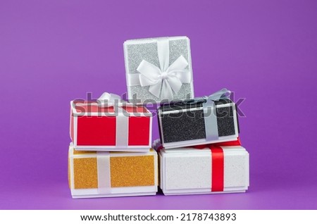 Large and small gift boxes on a purple background. Lots of gift boxes