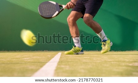 Monitor practicing paddle sport on the outdoor court. Man teaching padel class to his student. Professional people trainer how to play paddel. Learn a sport game concept. Royalty-Free Stock Photo #2178770321