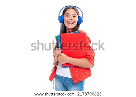 School girl, teenage student in headphones and books on isolated studio background. School kids with backpack. Portrait of emotional amazed excited teen girl. Royalty-Free Stock Photo #2178790623