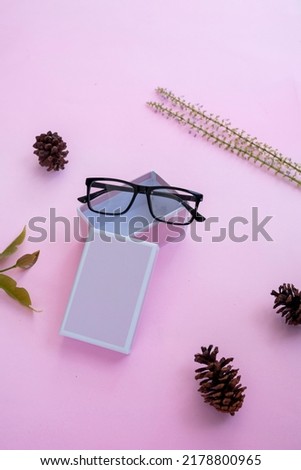 Fashion and beauty concept lying flat with square glasses, women's accessories on pink background. Product Presentation of Minimalist Concept Ideas
