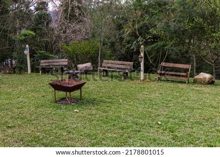 garden with benches and fireplace in the center in Bento Gonçalves, RS, Brazil