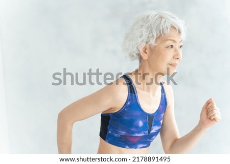 Asian sporty senior woman in the room