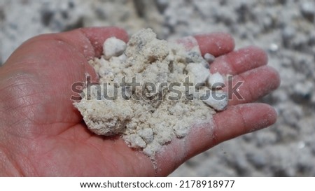 Human's hand holding gypsum powder, gypsum mine in mining industry area, Gypsum mining Royalty-Free Stock Photo #2178918977