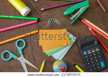 flat lay colorful creative, craft and office supplies on wooden table