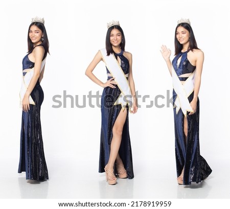 Full length body of Miss Beauty Pageant Contest wear blue evening sequin gown with diamond crown sash, Asian female stand express feeling happy smile over white background isolated Royalty-Free Stock Photo #2178919959