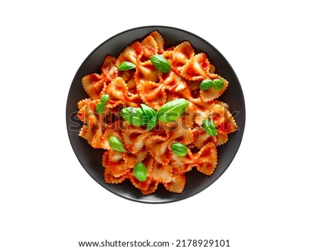 Farfalle, cooked pasta Italiano with tomato sauce and basil green leaves, top view, isolated on white background with clipping path. Royalty-Free Stock Photo #2178929101