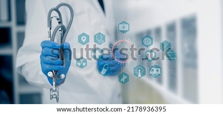 Medicine doctor holding a stethoscope with digital medical interface icons, Medical technology and network concept.