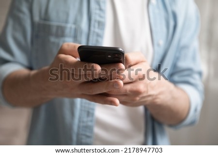 Crop close up of man hold modern smartphone gadget texting messaging using wireless internet connection, mobile network on device, male browse surf web on cellphone, communication, technology concept