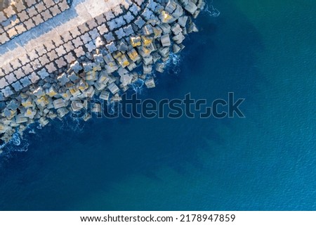 aerial drone view breakwater stone blocks blue calm sea Royalty-Free Stock Photo #2178947859