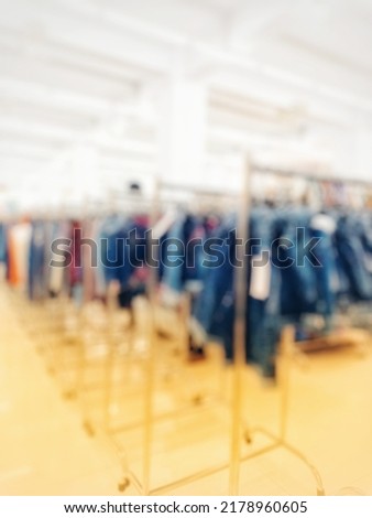 Blurred or out of focus abstract of fashion menswear shop boutique interior in shopping mall.