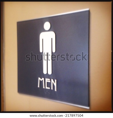 Close up image of a men's room sign