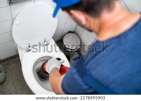 Plumber Toilet Blockage Assistance. WC Cleaning And Plumbing Royalty-Free Stock Photo #2178995903