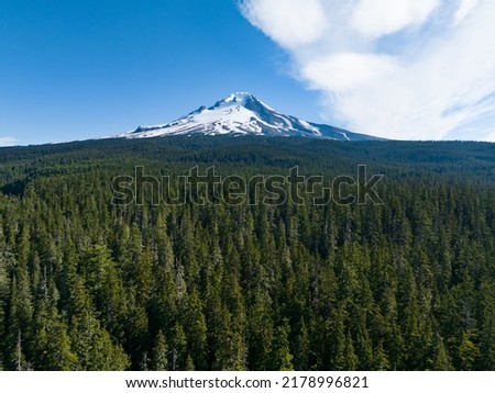 Mt. Hood rises from surrounding forest in Oregon, not far from Portland. This impressive mountain, part of the Cascade Range in the Pacific Northwest, is a potentially active stratovolcano. Royalty-Free Stock Photo #2178996821
