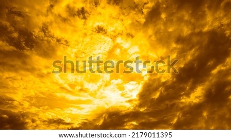  Gray yellow orange sky with clouds view. Dramatic skies background with space for design. Dark gloomy storm clouds. Lightning fire bright flash explosion in the sky. Armageddon, horror, scary,creepy