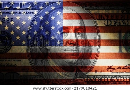 Economics and finance. A dollar bill in close-up and an American flag, double exposure. Picture of Benjamin Franklin. Concept of crisis of the banking system.
