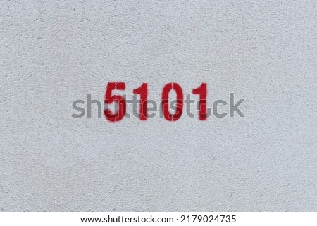 Red Number 5101 on the white wall. Spray paint.
