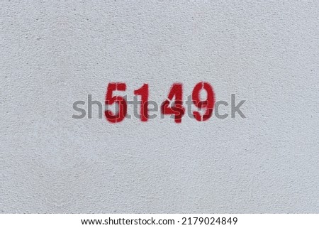 Red Number 5149 on the white wall. Spray paint.
