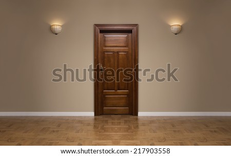 Close up of closed wooden door in the empty room with copy space Royalty-Free Stock Photo #217903558