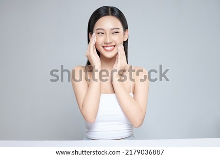 Attractive young Asian woman smile and uses cotton pad with toner for cleaning make up feeling so fresh and clean with healthy skin, isolated on white background. Royalty-Free Stock Photo #2179036887