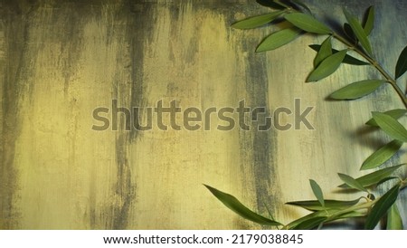 Olive branch on a grunge custom painted background. Symbol of peace and victory associated with customs of ancient Greece