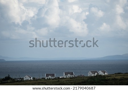 View of a few houses in distance and sea in the background in Achill Island, Ireland