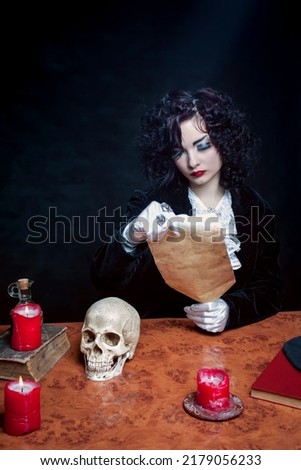 Young lady reading the scroll over dark background