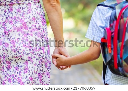 Back to school. Schoolboy is ready go to school. Cute child with a backpack outdoors. First day at school. Royalty-Free Stock Photo #2179060359