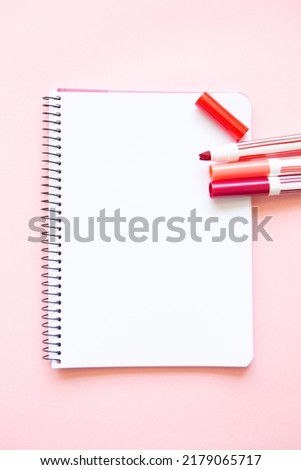 felt-tip pens of different shades of red and pink on a white background