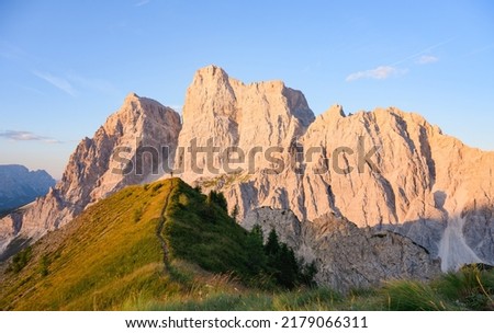 Stunning view of a person enjoying the view of Monte Pelmo from the summit of Col de la Puina. Monte Pelmo was the very first high mountain of the Dolomites that was climbed, Italy. Royalty-Free Stock Photo #2179066311