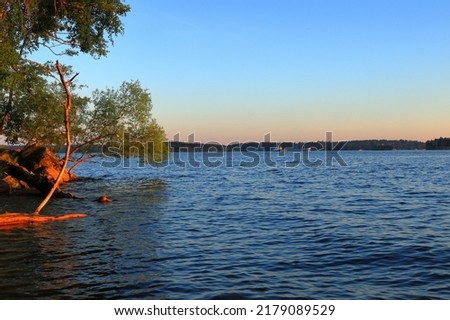 Scandinavian summer weather at a lake. Sunset or golden hour. Evening photo. June 2022. Close to the Baltic sea. Mälaren, Stockholm, Sweden, Scandinavia, Europe