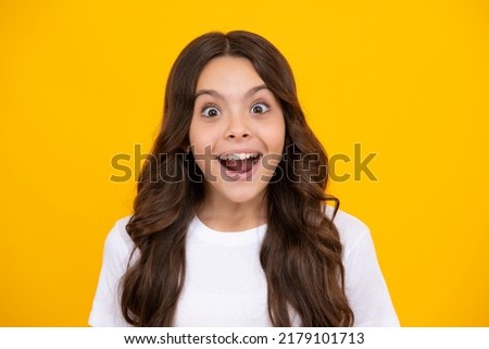 Amazed teen girl. Excited expression, cheerful and glad. Portrait of emotional positive teenage child girl shouting in amazement or astonishment face, astonished with surprise.