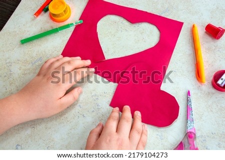 St. Valentines day theme. Crafts concept. Child makes art art project 