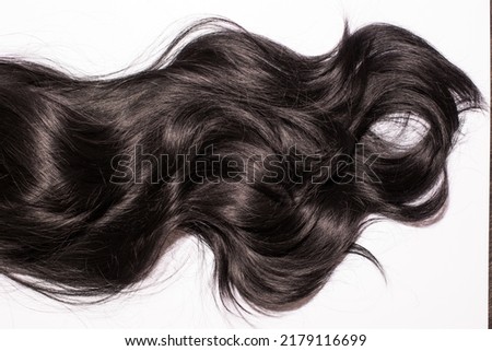 The close up of the texture of the shiny black human curly hair isolated on the white background Royalty-Free Stock Photo #2179116699
