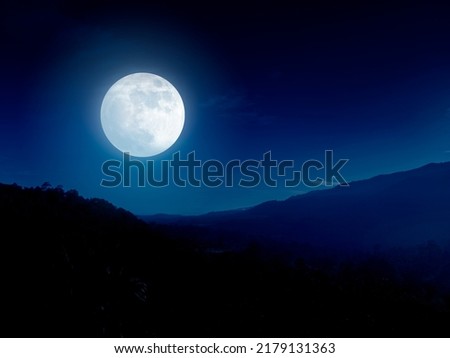 Full moon over mountain range. Night sky and mountain landscape