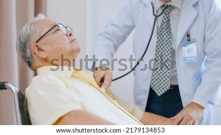 Asian senior patient having medical exam with doctor in hospital. Doctor listening heartbeat of male patient