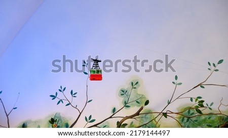 A red toy cable car in blue sky