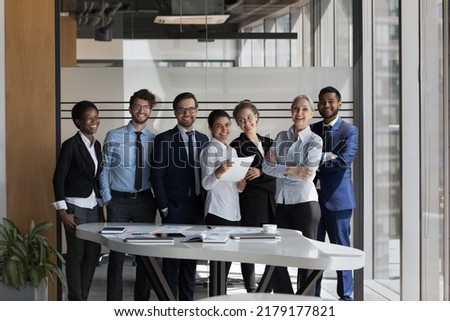 Happy confident multiethnic business team office portrait. Team of colleagues, businesspeople, students and teacher, interns and mentor celebrating job, career success, smiling, looking at camera