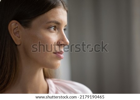 Profile view beautiful face serious young 30s woman. Close up thoughtful female staring into distance looks pensive, deep in thoughts. Daydream, eyesight care, laser vision correction services concept Royalty-Free Stock Photo #2179190465
