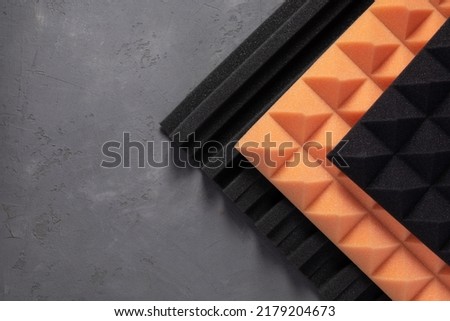 Acoustic foam material at concrete wall background texture. Foam rubber panel for record studio Royalty-Free Stock Photo #2179204673