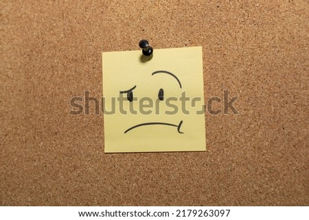 Confused and puzzled emotion face pin on sticky note on cork board concept using sticky notes Royalty-Free Stock Photo #2179263097