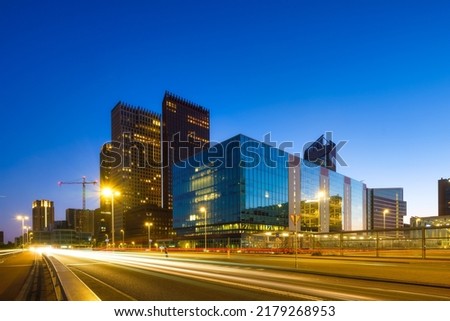 High office buildings in the business center of the city. Glass and steel. The city at night. Buildings and skyscrapers. Skyscrapers as a backdrop.