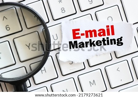 EMAIL MARKETING words on a small piece of paper located on a computer keyboard.