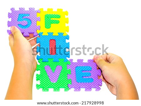 child playing alphabet puzzle