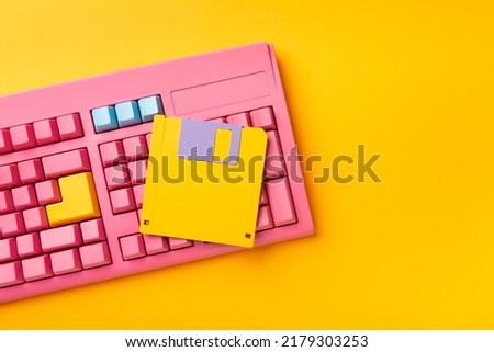 Floppy disks and keyboard on bright colored backgrounds. High quality photo
