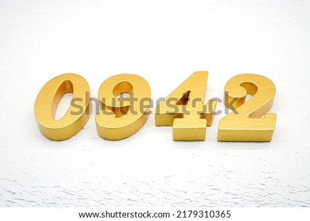   Number 0942 is made of gold painted teak, 1 cm thick, laid on a white painted aerated brick floor, visualized in 3D.                                   