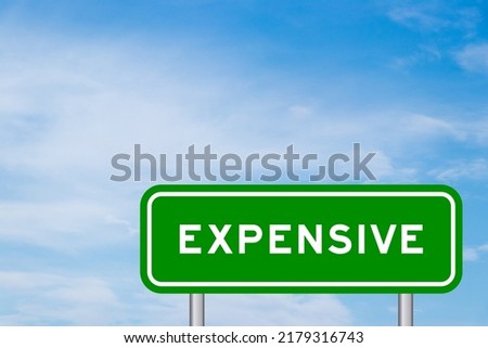 Green color transportation sign with word expensive on blue sky with white cloud background