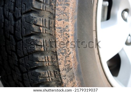 Wheel tire mess up with mud and dirt.