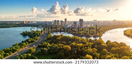 Panorama of Moscow at sunset, Russia. Nice landscape, scenery of city park and Strogino district in Moscow northwest. Aerial panoramic view of Moskva River bays. Scenic Moscow skyline in summer.  Royalty-Free Stock Photo #2179332073