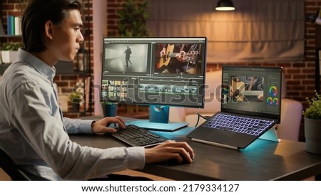 Editing artist working on footage design with media software, using visual effects to edit video montage for colorist production. Designing color gradient on computer. .
