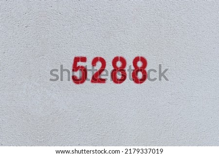 Red Number 5288 on the white wall. Spray paint.
